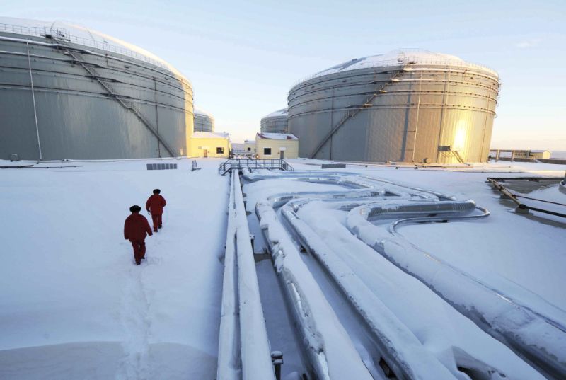 In this photo released by China's Xinhua News Agency, workers inspect the pipelines and oil storage tanks of China and Russia crude oil pipeline in Mohe, northeast China's Heilongjiang Province, Saturday, Jan. 1, 2011. The nearly 1, 000-kilometer (625-miles) -long China and Russia crude oil pipeline starts its full operation here Saturday and it will carry 15 million tons of crude oil annually from Russian oilfields into China in the next 20 years, according to Xinhua. The pipeline, a joint project conducted by PetroChina, China's largest oil and gas producer, and Rosnef, Russia's largest oil company, is part of Russia's 4, 000-kilometer (2,500-mile) East Siberia to Pacific Ocean Pipeline Shipment project, Xinhua also said. (AP Photo/Xinhua, Wang Jianwei) NO SALES