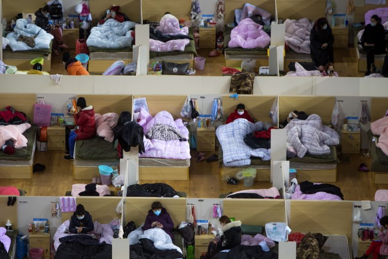 In this Monday, Feb. 17, 2020, photo released by Xinhua News Agency, patients infected with the coronavirus take rest at a temporary hospital converted from Wuhan Sports Center in Wuhan in central China's Hubei Province. China reported thousands new virus cases and more deaths in its update Tuesday on a disease outbreak that has caused milder illness in most people, an assessment that promoted guarded optimism from global health authorities. (Xiao Yijiu/Xinhua via AP)