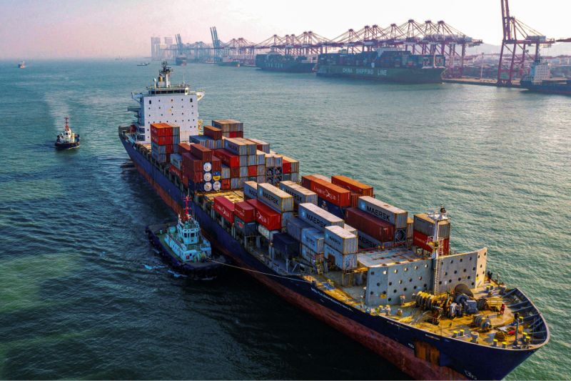 A cargo ship loaded with containers makes its way at a port in Qingdao in China's eastern Shandong province on January 14, 2020. - China's trade surplus with the United States narrowed last year as the world's two biggest economies exchanged punitive tariffs in a bruising trade war, official data showed on January 14, on the eve of a deal to ease tensions. (Photo by STR / AFP) (Photo by STR/AFP via Getty Images)