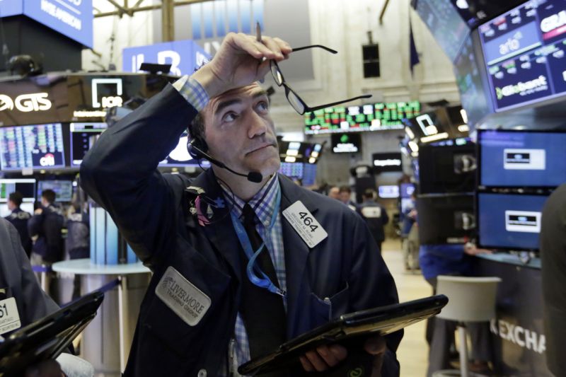 FILE- In this Aug. 28, 2018, file photo trader Gregory Rowe works on the floor of the New York Stock Exchange. The bull market for U.S. stocks is now 10 years old and the longest since World War II. That lifespan speaks to financial markets' resiliency in the face of a variety of shocks, including a brutal fourth quarter of 2018. (AP Photo/Richard Drew, File)