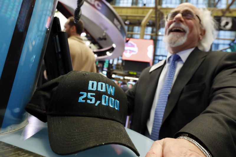 FILE- In this Jan. 30, 2019, file photo trader Peter Tuchman smiles as he poses with an old "Dow 25,000" hat on the New York Stock Exchange trading floor. The bull market in stocks started with the U.S. still reeling from the Great Recession in March 2009. The bull turns 10 this weekend, having survived threats such as a debt crisis in Europe (2011), a slowdown in the Chinese economy (2015-2016), and fears of inflation and rising interest rates in the U.S. (AP Photo/Richard Drew, File)