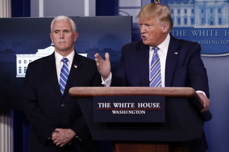 President Donald Trump speaks about the coronavirus in the James Brady Briefing Room, Monday, March 23, 2020, in Washington, as Vice President Mike Pence listens. (AP Photo/Alex Brandon)