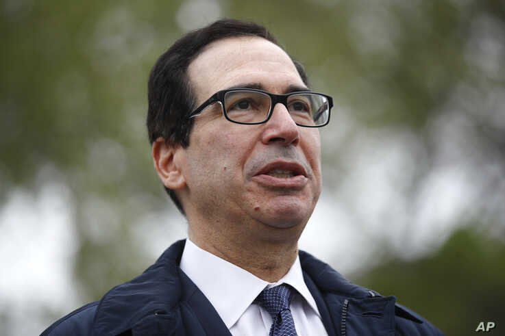 Treasury Secretary Steve Mnuchin speaks with reporters about economic impacts of the coronavirus outside the White House,…