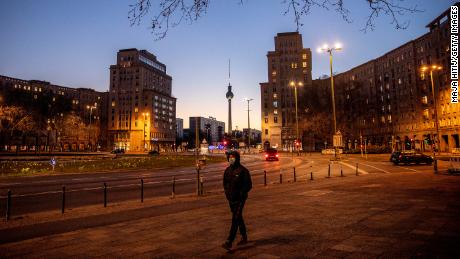  A man with a mask passes by an empty street during the coronavirus crisis in Berlin, Germany. 