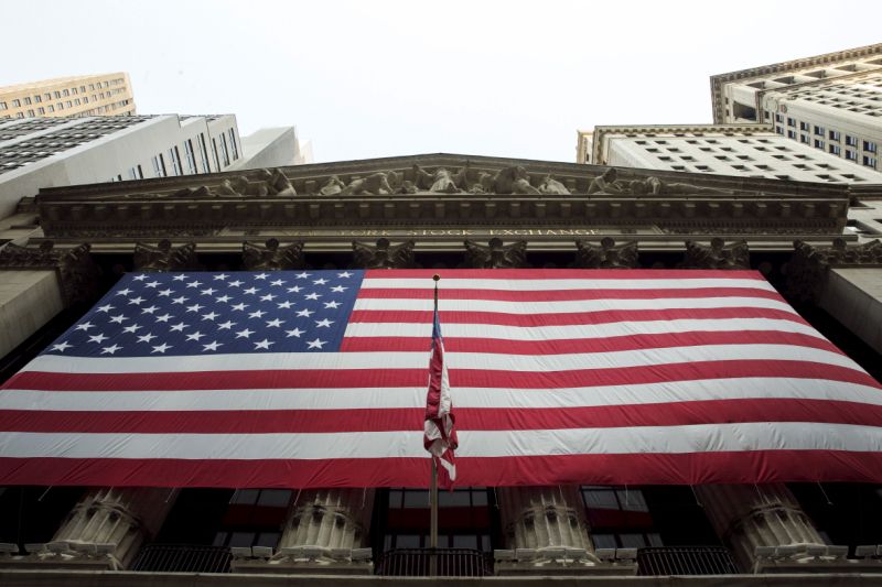 A large U.S. flag hangs on the facade of the New York Stock Exchange in New York September 3, 2015. REUTERS/Lucas Jackson 