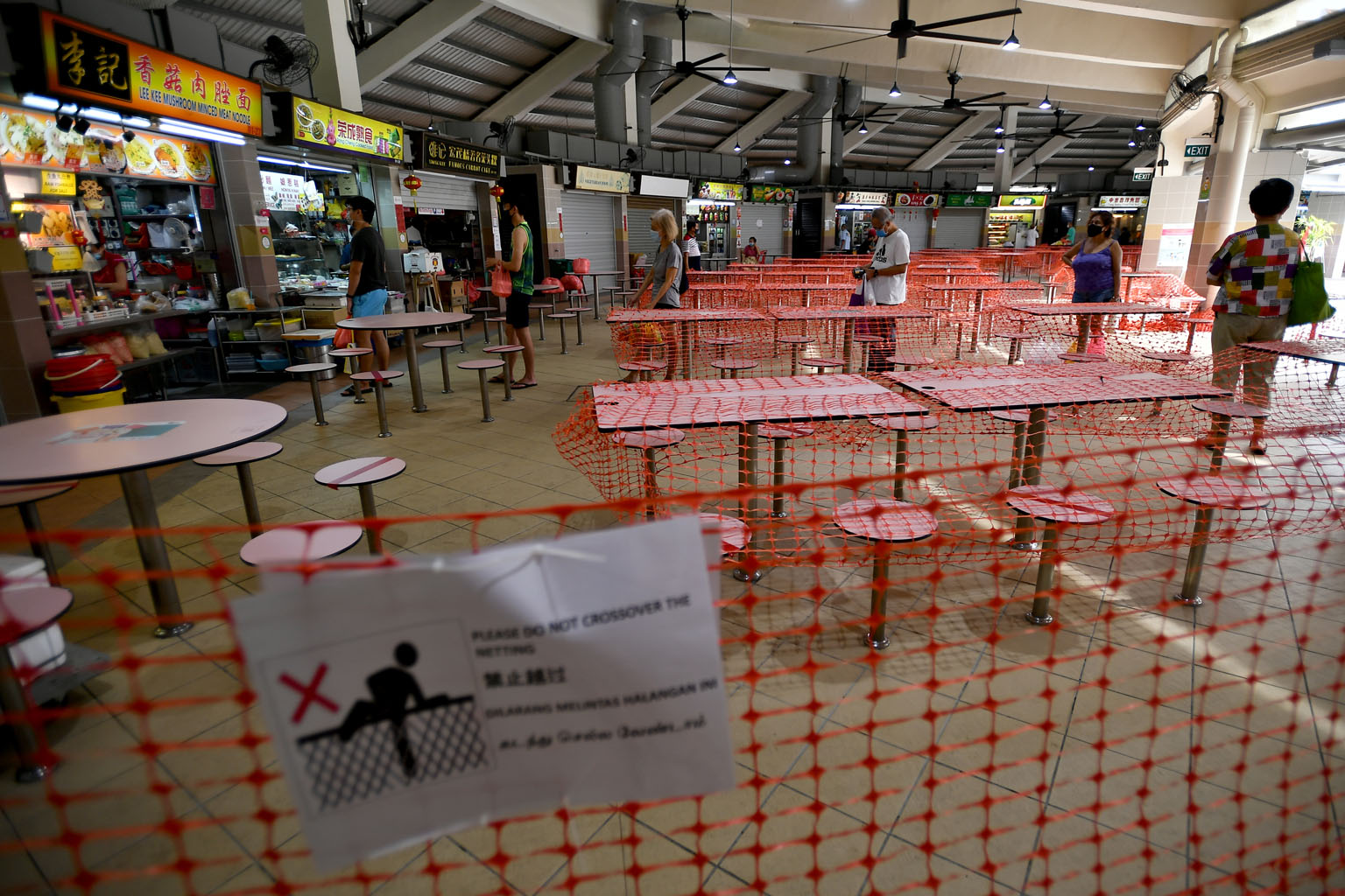 Patrons observing safe distancing while queueing for food at Tampines Round Market &amp; Food Centre last Tuesday. This is part of the Government's precautionary measures for public health amid the coronavirus pandemic.