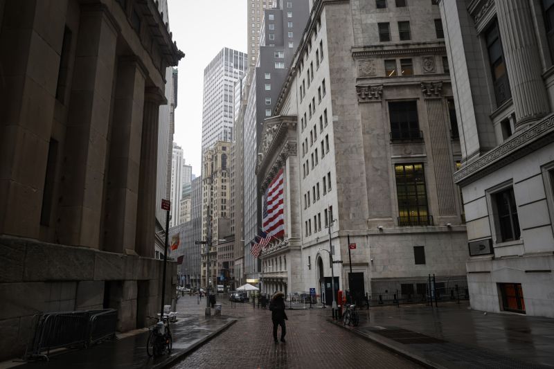 A pedestrian walks on an nearly empty Wall St., near the New York Stock Exchange (NYSE) as the coronavirus disease (COVID-19) outbreak continues in New York City, New York, U.S., March 23, 2020. REUTERS/Mike Segar