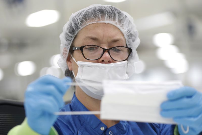 Jody Barrowman works on making protective masks in Warren, Mich., Thursday, April 23, 2020. General Motors has about 400 workers at the now-closed transmission plant in suburban Detroit. All over the country, blue-collar and salaried workers have raised their hands to make medical equipment as companies repurpose factories to answer calls for help from beleaguered nurses, doctors and paramedics who are treating patients with the highly contagious new coronavirus COVID-19. (AP Photo/Paul Sancya)