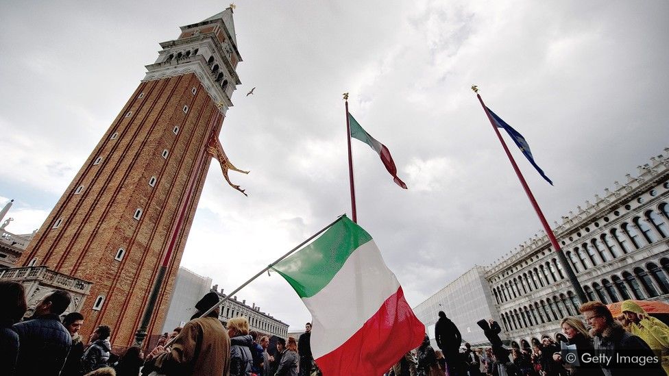 Flags fly in Venice during a one-off holiday in Italy in 2011. It was found to have a positive economic impact – unlike proposed holidays in other countries (Credit: Getty Images)