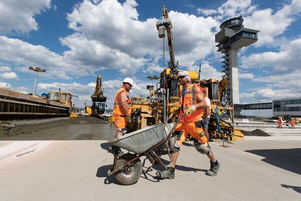 Workers at the Berlin Brandenburg Airport, which is under construction in Germany.