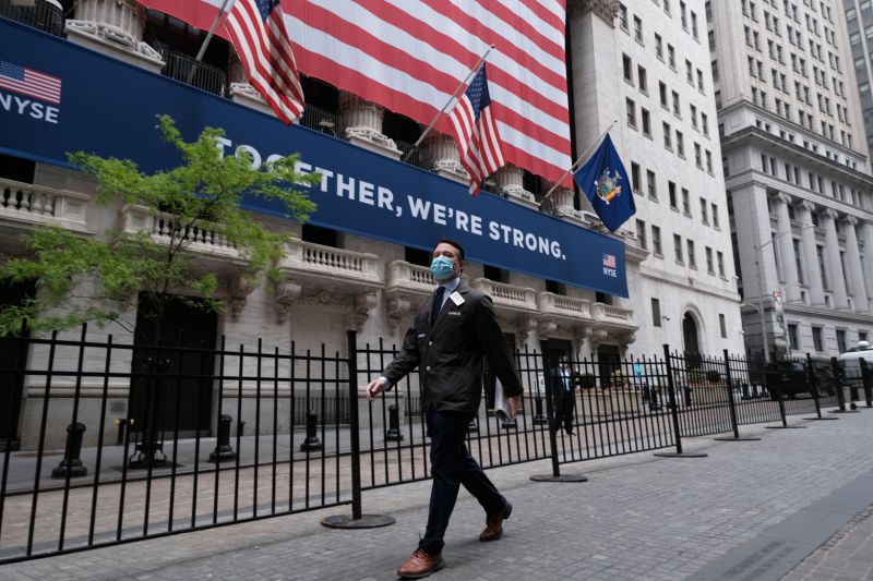 NEW YORK, NEW YORK - MAY 26: A trader walks by the New York Stock Exchange (NYSE) on the first day that traders are allowed back onto the historic floor of the exchange on May 26, 2020 in New York City. While only a small number of traders will be returning at this time, those that do will have to take temperature checks and wear face masks at all times while on the floor. The Dow rose over 600 points in morning trading as investors see economic activity in America picking up (Photo by Spencer Platt/Getty Images)