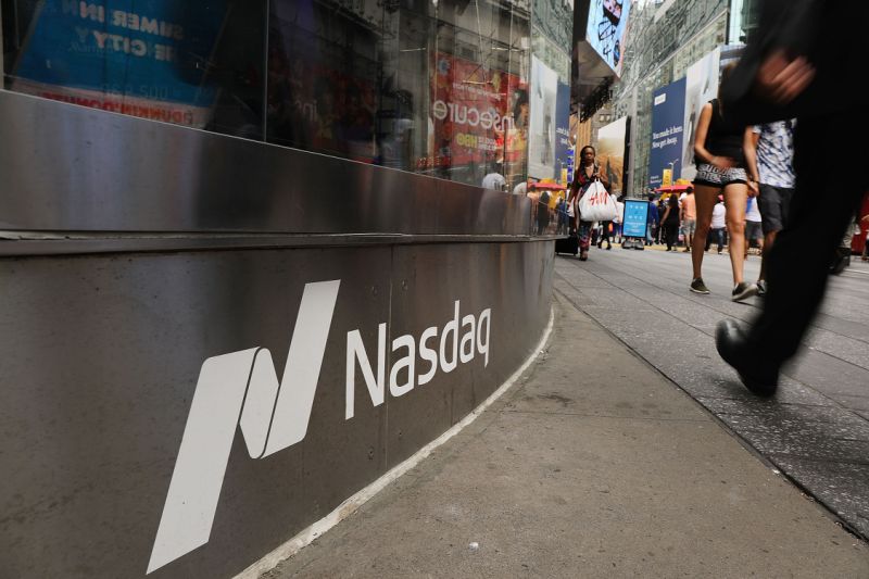 NEW YORK, NY - JULY 30: People walk by the Nasdaq MarketSite in Times Square on July 30, 2018 in New York City. As technology stocks continued their slide on Monday, the Nasdaq Composite dropped 1.1 percent in afternoon trading with shares of Facebook, Netflix, Amazon and Google-parent Alphabet all declining. (Photo by Spencer Platt/Getty Images)