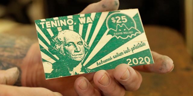 In an effort to help residents and local merchants alike get through the economic fallout of the coronavirus pandemic, the small town has issued wooden currency for residents to spend at local businesses, decades after it created a similar program during the Great Depression. (AP Photo/Ted S. Warren)