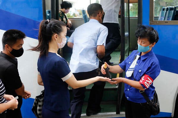 Commuters being disinfected in Pyongyang this month.