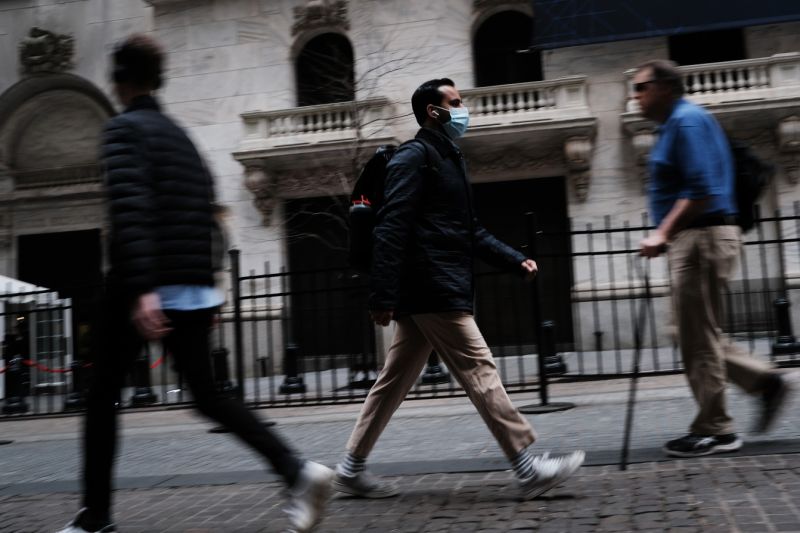 NEW YORK, NEW YORK - MARCH 10: A man in a medical mask walks by the New York Stock Exchange (NYSE) on March 10, 2020 in New York City. After losing nearly 8 percent in a market rout yesterday, the Dow Jones Industrial Average was up over 700 points in morning trading as investors look to a possible tax cut and other measures by the Trump administration to combat the coronavirus. (Photo by Spencer Platt/Getty Images)