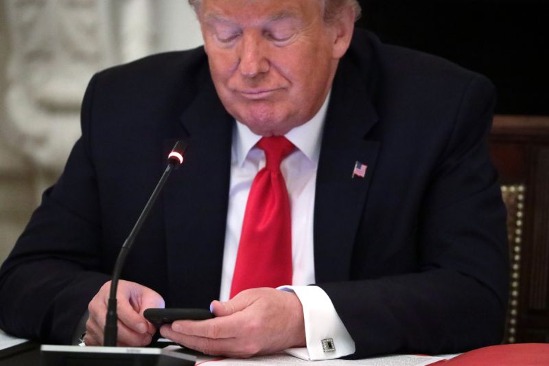 WASHINGTON, DC - JUNE 18: U.S. President Donald Trump looks at his phone during a roundtable at the State Dining Room of the White House June 18, 2020 in Washington, DC. President Trump held a roundtable discussion with Governors and small business owners on the reopening of American’s small business. (Photo by Alex Wong/Getty Images)