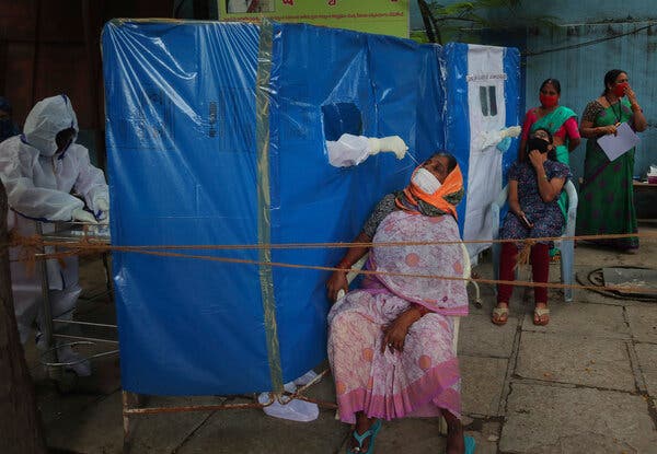 A health worker taking a nasal sample to test for Covid-19 in Hyderabad, India.