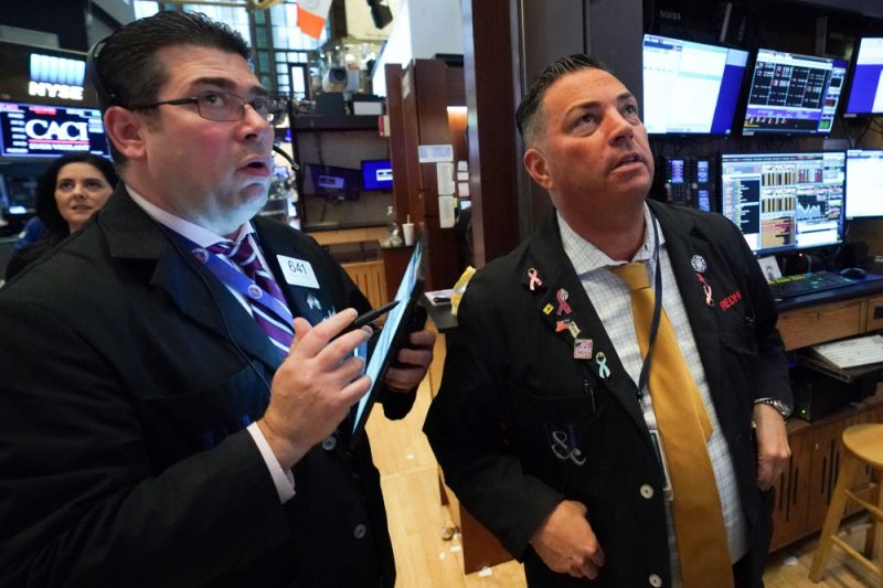 Traders work on the floor at the closing bell of the Dow Industrial Average at the New York Stock Exchange on March 11, 2020 in New York. - Wall Street stocks dove deeper into the red in afternoon trading on March 11, 2020, with losses accelerating after the World Health Organization declared the coronavirus a global pandemic. Near 1710 GMT, the Dow Jones Industrial was down more than 1,200 points, or 5.0 percent, at 23,777.17. The broad-based S&P 500 slumped 4.6 percent to 2,749.88, while the tech-rich Nasdaq Composite Index tumbled 4.4 percent to 7,979.15. (Photo by Bryan R. Smith / AFP) (Photo by BRYAN R. SMITH/AFP via Getty Images)