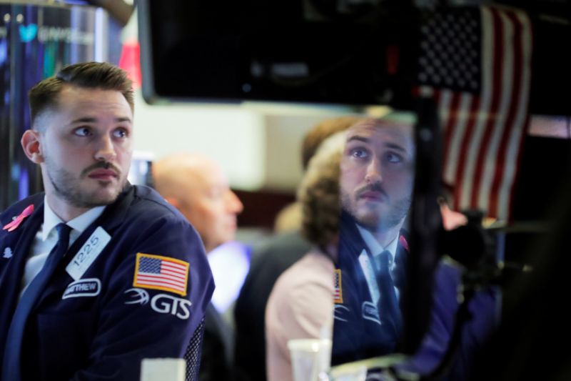 A trader working on the floor of the New York Stock Exchange (NYSE) is reflected on a monitor in Manhattan in New York, U.S., October 10, 2018. REUTERS/Brendan McDermid