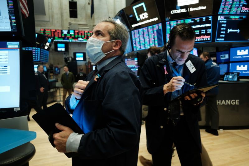 NEW YORK, NEW YORK - MARCH 20: Traders, some in medical masks, work on the floor of the New York Stock Exchange (NYSE) on March 20, 2020 in New York City. Trading on the floor will temporarily become fully electronic starting on Monday to protect employees from spreading the coronavirus. The Dow fell over 500 points on Friday as investors continue to show concerns over COVID-19. (Photo by Spencer Platt/Getty Images)